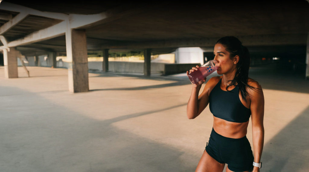 women drinking after workout