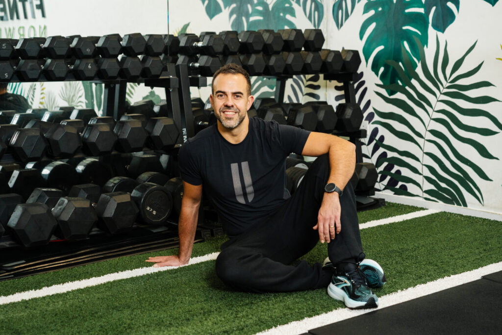 Xavi Gomez sitting by dumbbells